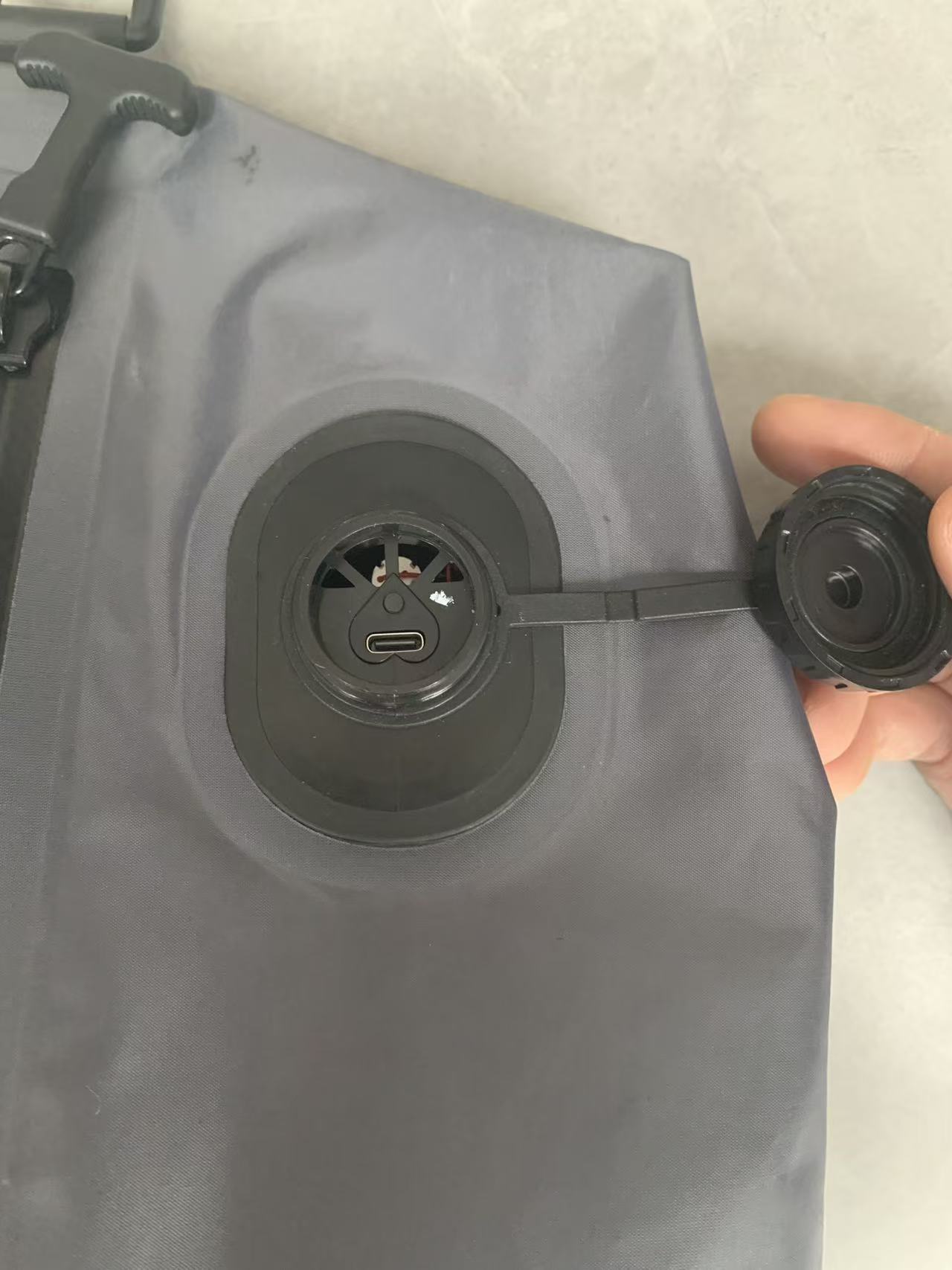 threaded waterproof cap over USB-C port on compression bag